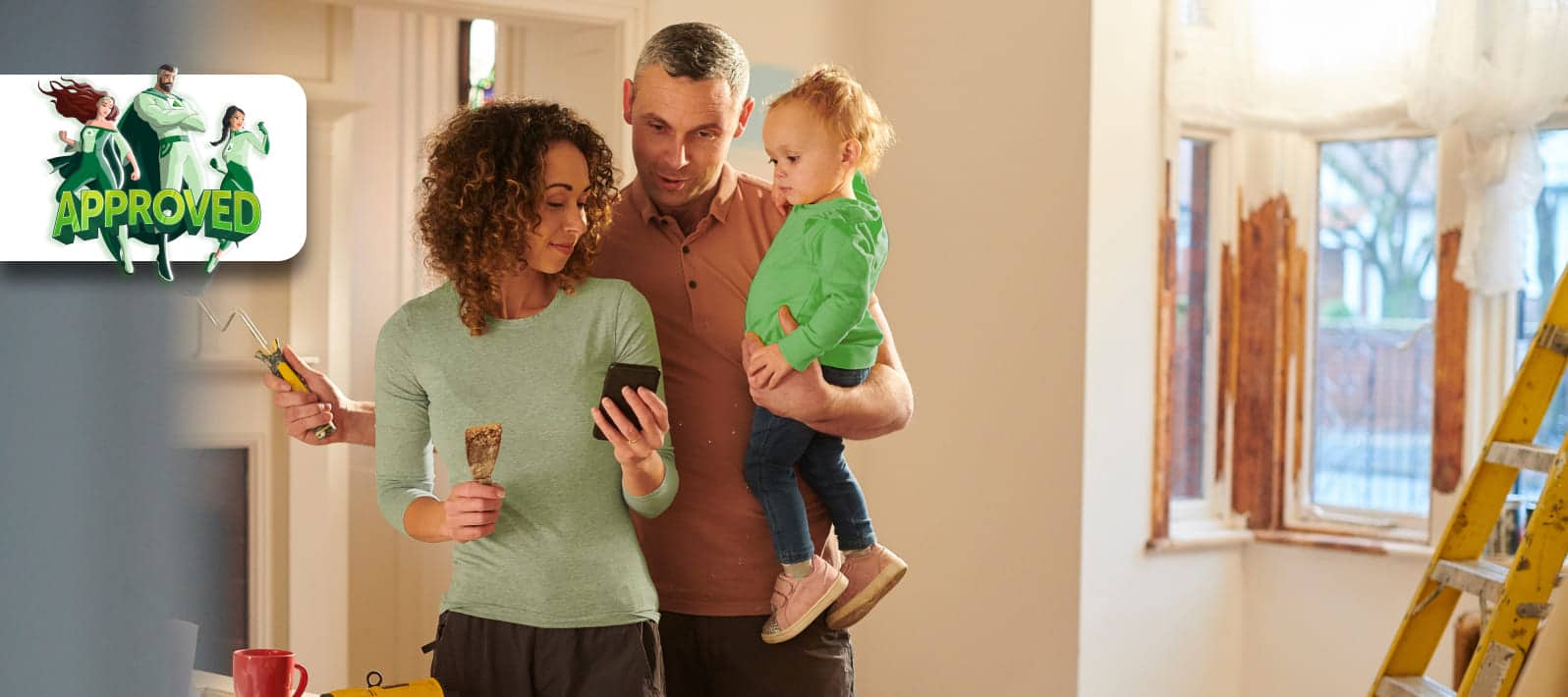 a man and woman holding a baby while home renovating